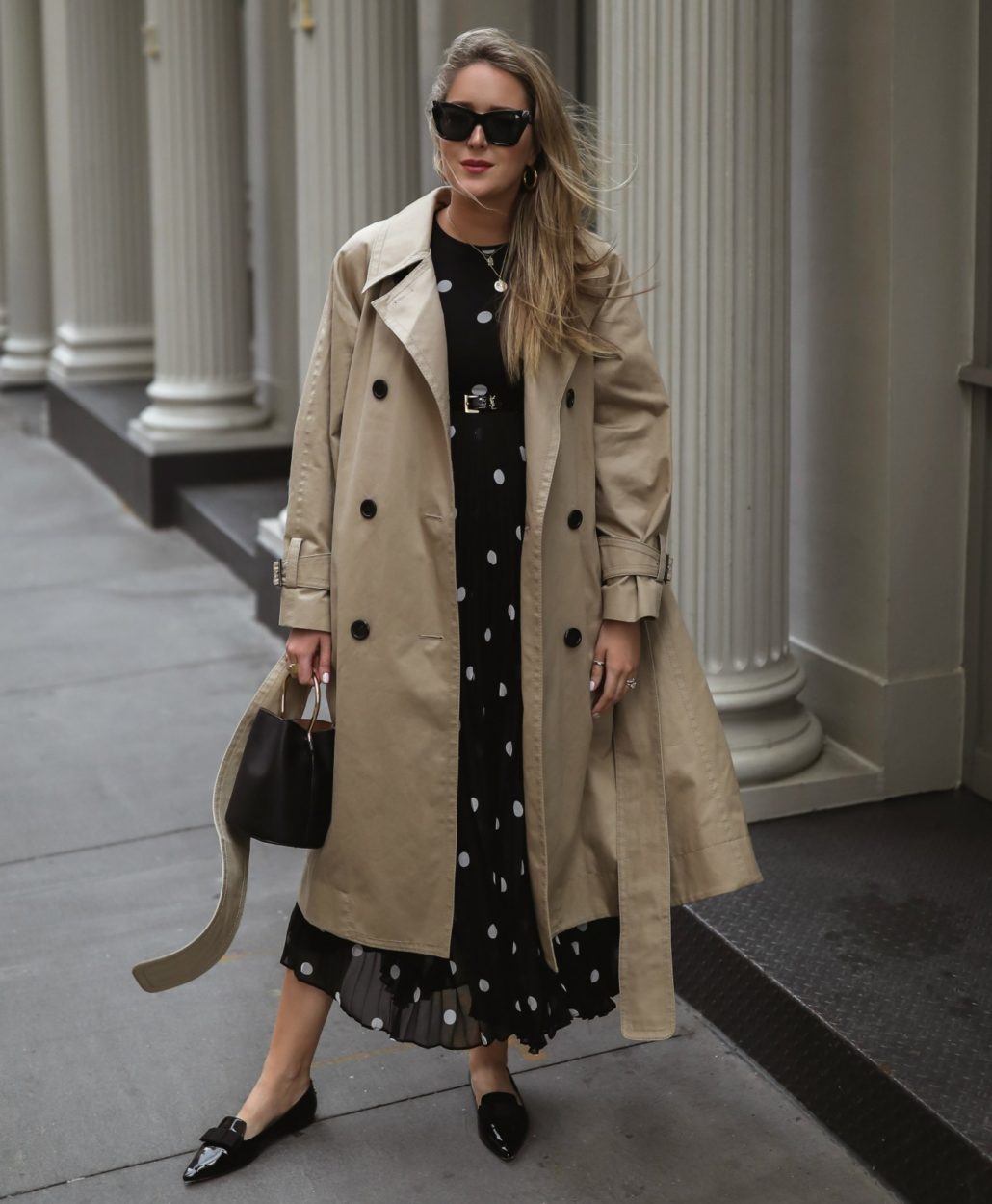 Mary in a trench coat and polka-dot dress in 2019