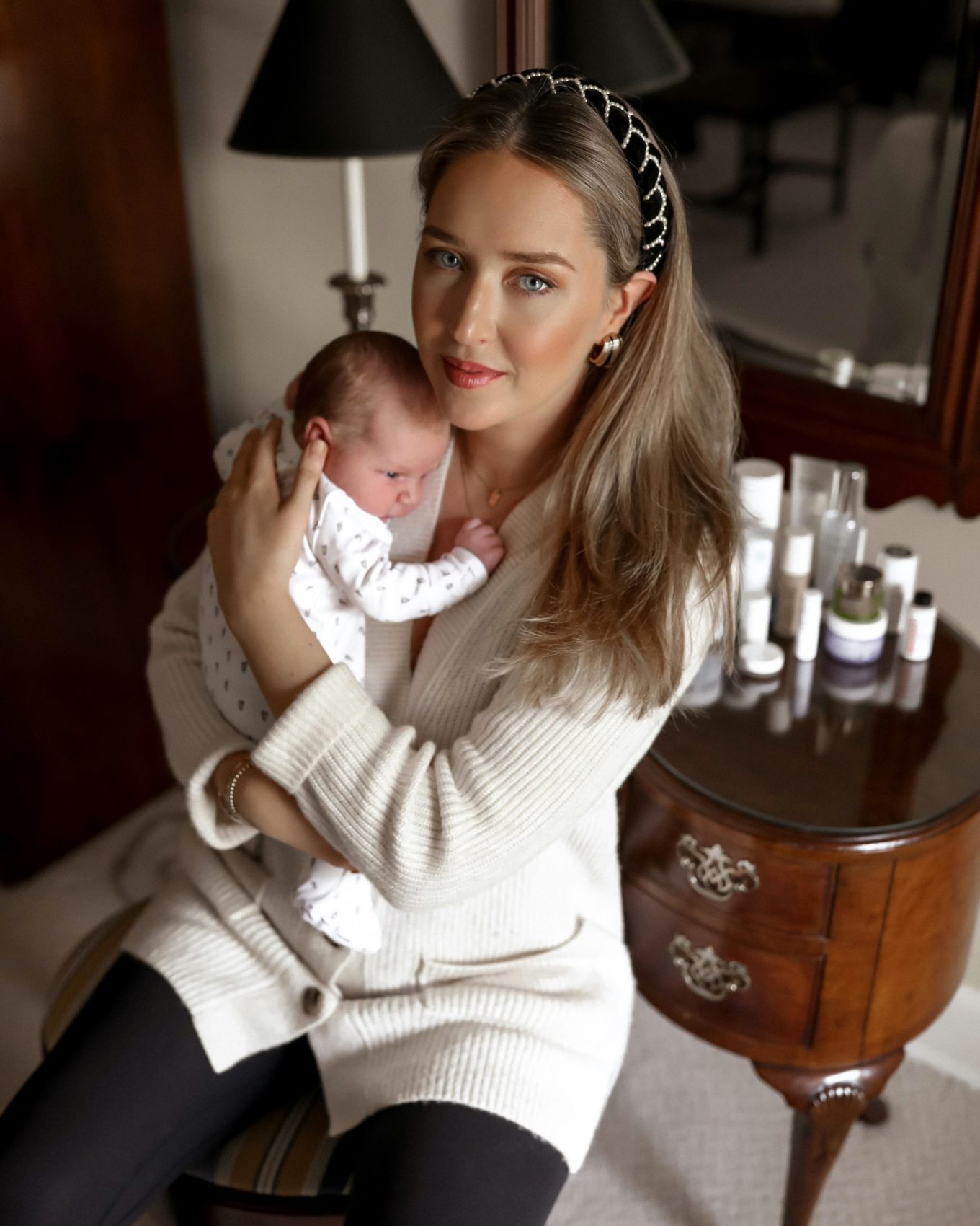 woman holding her child and showing clean beauty brands for pregnancy and postparum