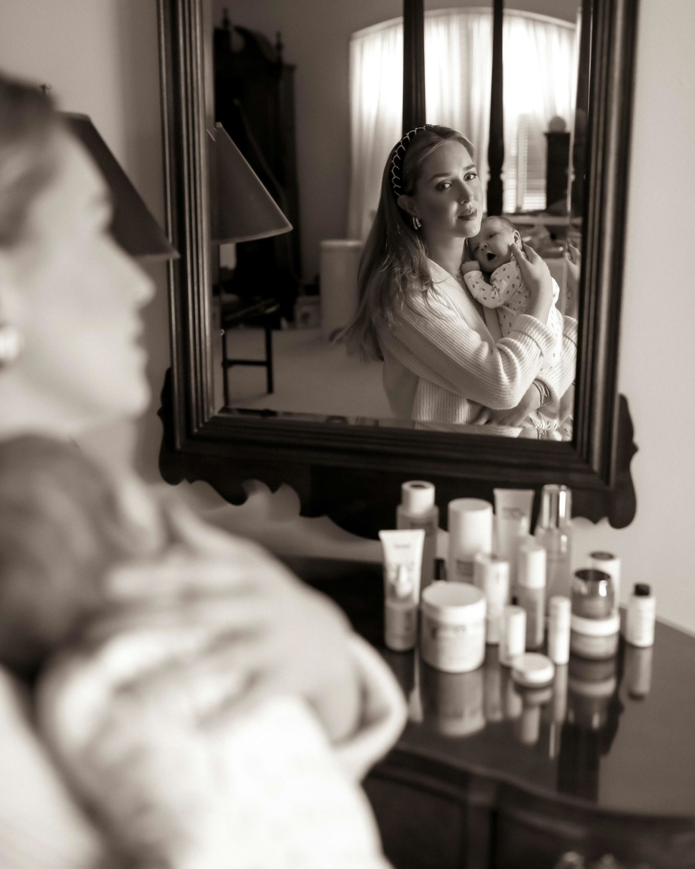 woman holding her child and showing clean beauty brands for pregnancy and postparum