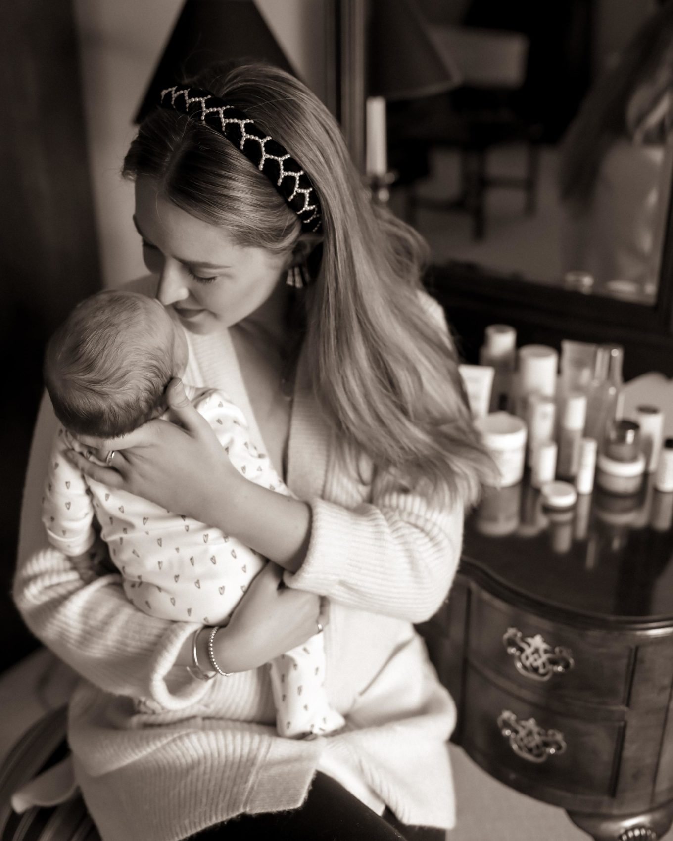 woman holding her child and showing clean beauty brands for pregnancy and postparum